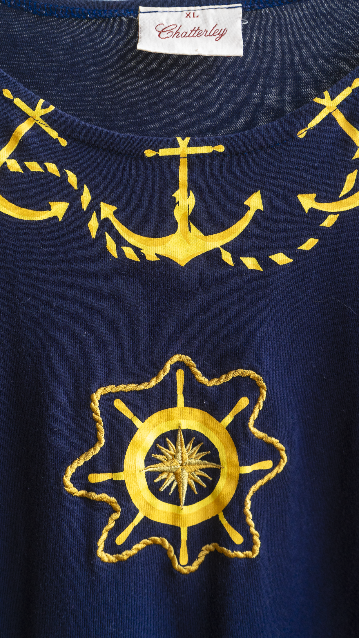 detail of gold anchor and steering wheel   slash compass design on navy vintage nightwear t-shirt fresh vintage