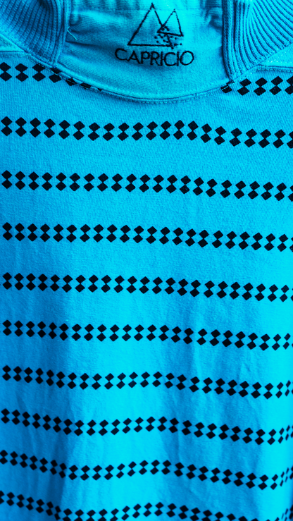 close-up of 80s sweater from brand capricio with turtleneck and tiny black diamond shaped dots in rows of two