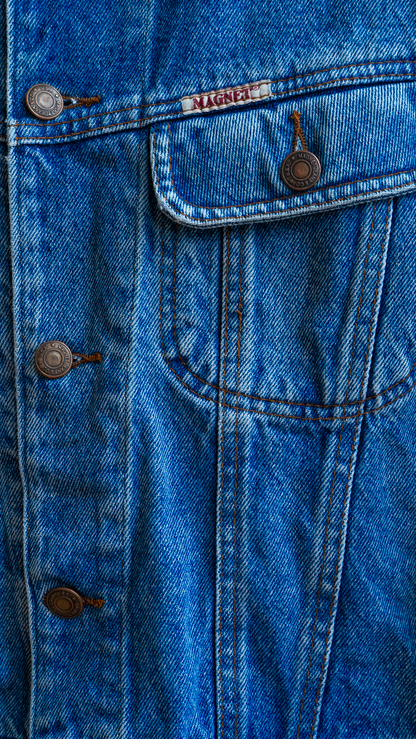 close-up of early 90s slightly cropped vintage jeans jacket in blue by fashion brand 'magnet' giving the left chest pocket and a tinier label or logo of 'magnet' above it Fresh Vintage