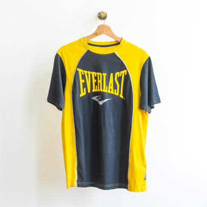 Black, yellow and gray 'Everlast' t-shirt on a hanger against a white background