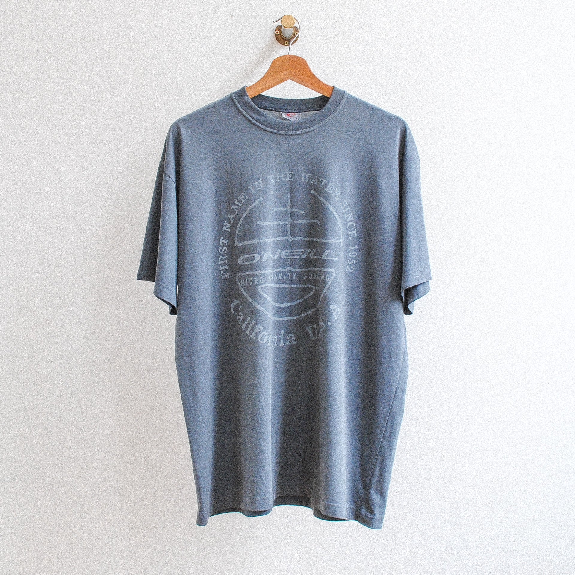 grey o'neill tshirt in center o'neill logo text around firt name in the water since 1952 california usa 2000s style
