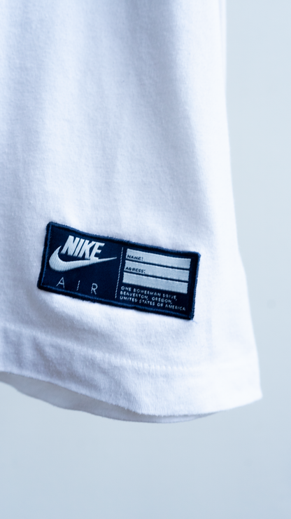 Close-up of a Nike Air label on a white blue red 80s shirt