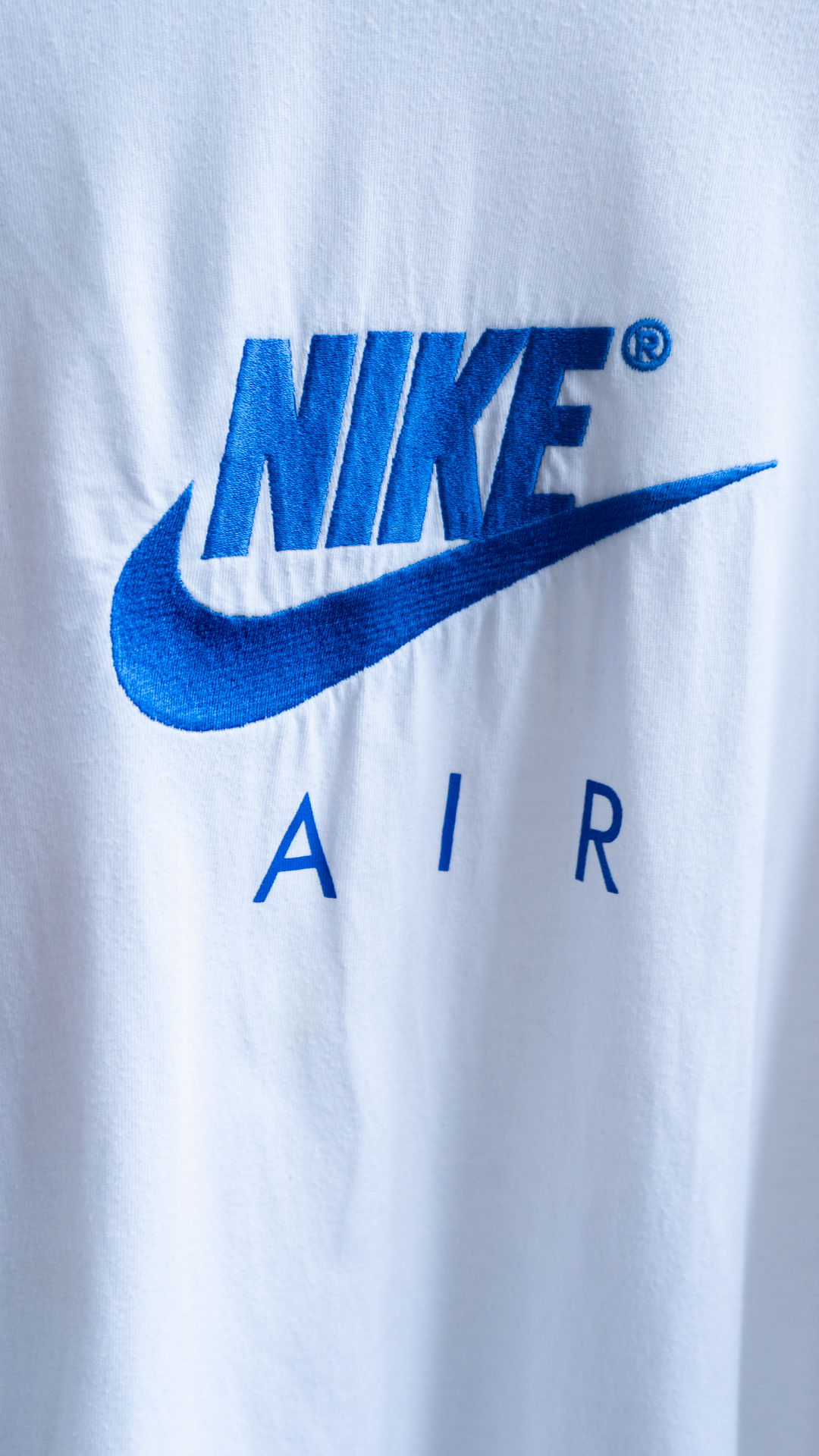 Nike Air logo on a retro white red and blue vintage T-shirt