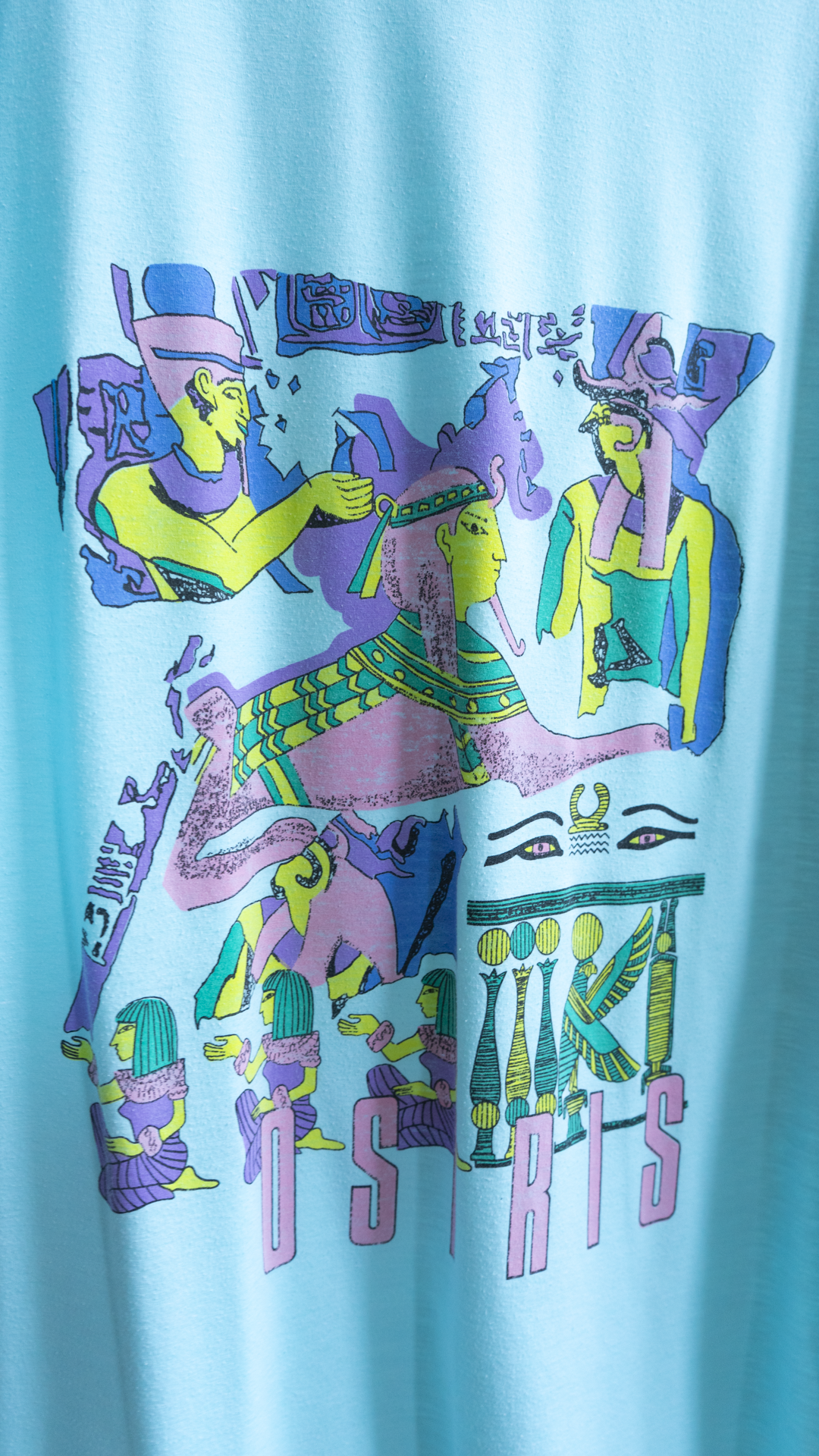 image of egyptian figures on light blue oversized vintage t-shirt