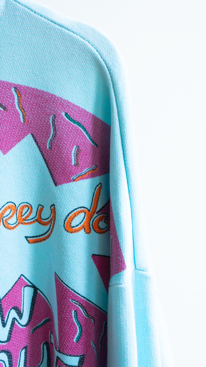 detail light blue secondhand 80s sweater with comic graphics