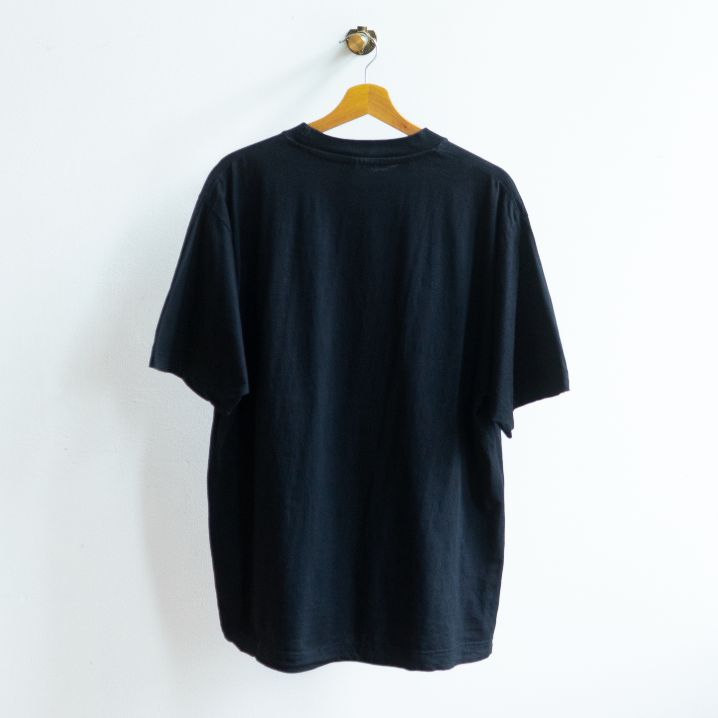 back of secondhand black flower power T-shirt